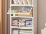 a white bookcase with lots of pillows and blankets on it