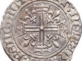 a close up of a coin with a cross on it