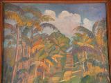 a painting on the wall of a room with a wooden frame