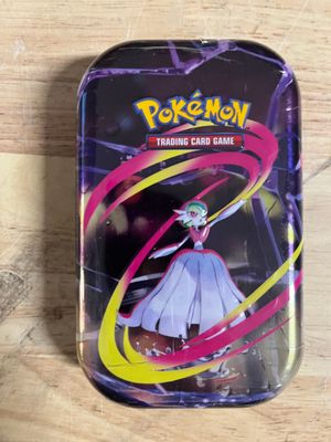 a small tin with a picture of a woman in a dress on it