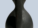a black bird statue that is on a blue background