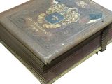 an old book with a coat of arms on it