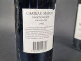 a bottle of wine sitting next to a bottle of wine