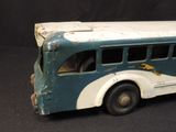 a toy bus that is sitting on a black surface