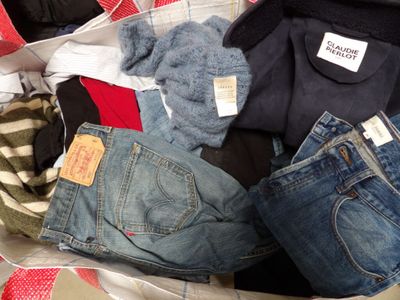 a pile of clothes that is sitting in a suitcase