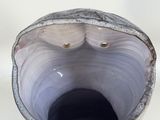 a close up of a vase on a white surface