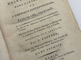 an old book that is open on a table