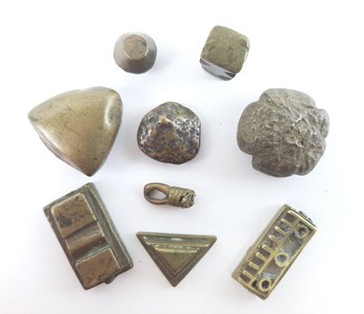 several pieces of metal on a white surface with a white background