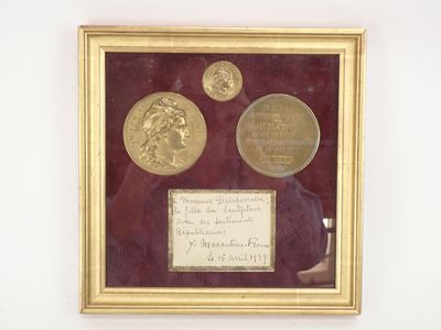 framed photograph of three gold coins and a note in a gold frame