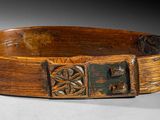 an old wooden bowl sitting on top of a white surface