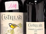 several bottles of wine are lined up on a shelf in a store