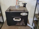 a small black oven sitting on a table in a room