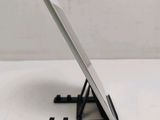 a tablet computer sitting on a stand on a table