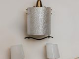 two lamps that are on the wall next to each other