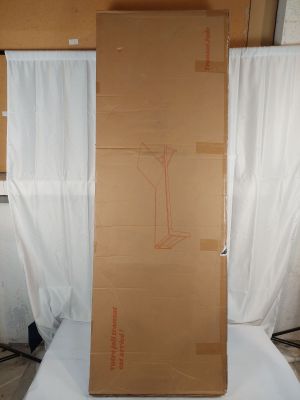 a large cardboard box sitting on top of a bed