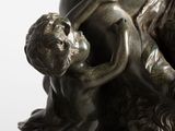 bronze statue of a woman holding a child on her back