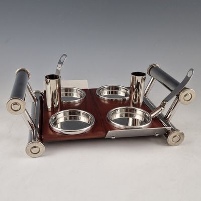 a silver plate with two bowls and spoons on it
