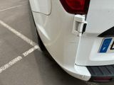 a white van parked in a parking lot with its door open