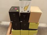 a stack of boxes and a glass of wine on a pallet