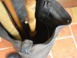 someone is holding an umbrella in a black bag on a tiled floor
