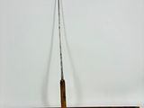 a close up of a fishing rod on a white background