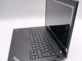 a laptop with a black keyboard on a white surface