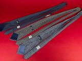 four ties laid out on a red surface with a red background