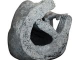 a stone sculpture of a cat with its mouth open
