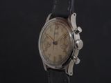 a close up of a watch on a black background