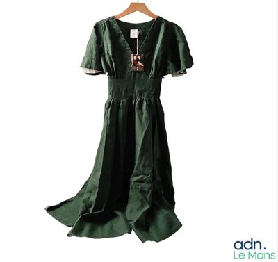 a picture of a green dress on a hanger