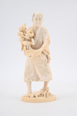 an antique ivory figurine of a woman holding a basket of flowers