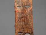 a wooden mask with a face made out of wood