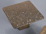 pair of square marble tables with square bases on a gray surface