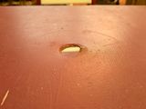 a hole in the top of a table that has a small hole in it