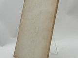 an old book sitting on top of a table next to a white background