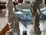 a glass table with statues on it in a living room