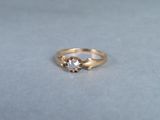 a close up of a gold ring with a diamond on it