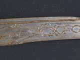 a knife that has been carved into a piece of wood