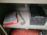 a metal shelf with a red box and a wren on it