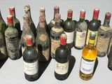 many bottles of wine sitting next to each other on a table