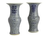 pair of blue and white vases with chinese characters on them