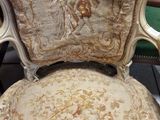 a chair that is sitting in a room with a lot of furniture