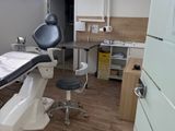 a room with a table, chair, and other medical equipment in it