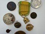 a small collection of medals and medals on a table