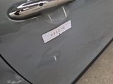a close up of a car door handle with a sticker on it