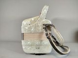 a white bag with a strap on it sitting on a table