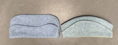 two pieces of felt sitting on a table next to each other