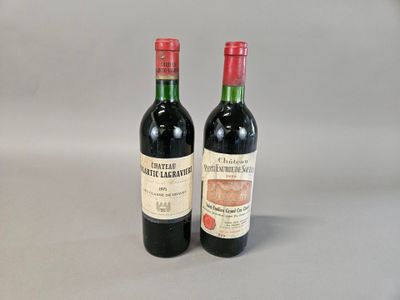 two bottles of red wine sitting next to each other on a table