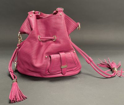 a close up of a pink purse with a tassel on it