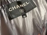 a close up of a chanel label on an orange jacket